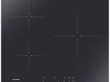 a close up of a black stove top with four burners