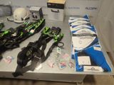 many skis and snowboards on a table in a room