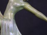 statue of a woman in a flowing dress holding a bird