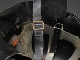 a black helmet with a leather strap on top of it