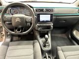 the interior of a car with a steering wheel and dashboard controls