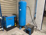 a large blue tank and a small blue machine in a garage
