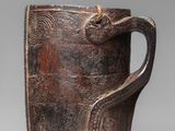 an image of a brown cup with a handle on a gray background