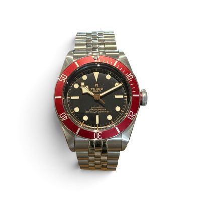 an image of a red and black watch on a white surface