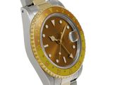an image of a yellow and silver watch with a yellow bezel
