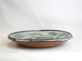 a close up of a bowl on a white surface