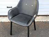 a black chair sitting in front of a garage door