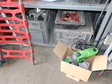 a box of tools sitting on the floor next to a chair