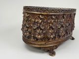 a large metal bowl on a stand on a white surface