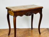an image of a wooden table with a marble top on a parquet floor