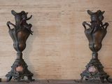 two vases that are sitting on a shelf next to each other