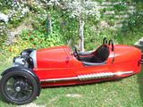 a red car that is sitting in the grass