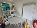 an image of a room with a whiteboard and a white table