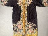 a black and gold embroidered jacket with flowers on it