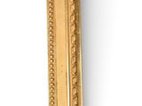 a picture of a gold picture frame on a white wall