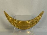 a gold plate with a plaque on it on a stand