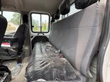 a seat in the back of a van that is covered with plastic