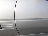 a silver car that has been painted silver and is parked on the side of the road