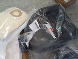 many items that are wrapped in plastic bags on the floor