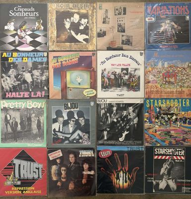 several albums of various music are displayed on a wall