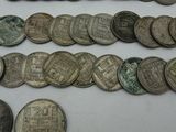 some old coins are sitting on a white surface