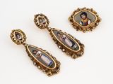 three pairs of antique gold - plated earrings with a picture of a man and woman