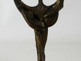 bronze statue of a woman holding a bird on a white background