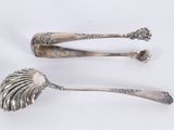two spoons that are sitting on a white surface