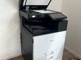 a black and white printer sitting on top of a white cabinet