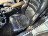 a picture of the inside of a car with black leather seats