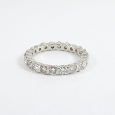 a close up of a diamond ring on a white surface