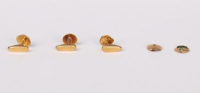 three pairs of gold stud earrings on a white surface