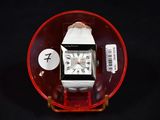 a watch that is sitting in a glass bowl