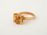 a close up of a gold ring with a citrine stone
