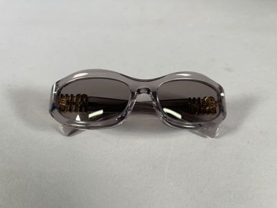 a close up of a pair of sunglasses on a white surface