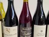 several bottles of wine are lined up in a row on a table