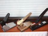 a stapler, stapler, stapler, and stapler on a desk