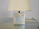 a glass table with a lamp on top of it