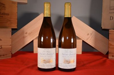 two bottles of wine sitting next to each other on a table