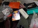 a pile of clothing and other items on a bed