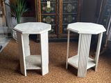 two white side tables sitting on top of a carpeted floor