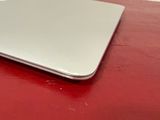 a laptop computer sitting on top of a red table