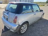 a small silver car that is parked in the parking lot
