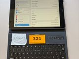 a tablet computer sitting on top of a laptop keyboard