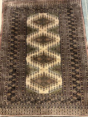 rug on the floor of a room with a blue and white rug on the floor