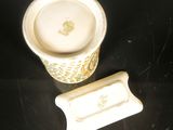 a small cup with a lid sitting next to a smaller cup