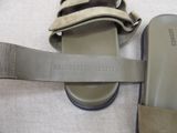 a pair of sandals and a cell phone laying on a bed