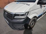 a white van parked in a parking lot next to a building