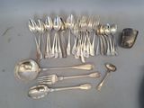 a lot of silver spoons and spoon spoons on the table