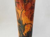 a vase with a painting on it sitting on a table